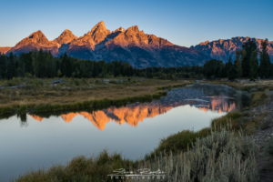 A beautiful sunrise over Schwabachers Landing in the Grand Tetons.  It was around 27 degrees this morning and there were photographers lined up and down this river bank.  It's a little difficult to see in this image, but the brown spot in the middle is a grazing moose.